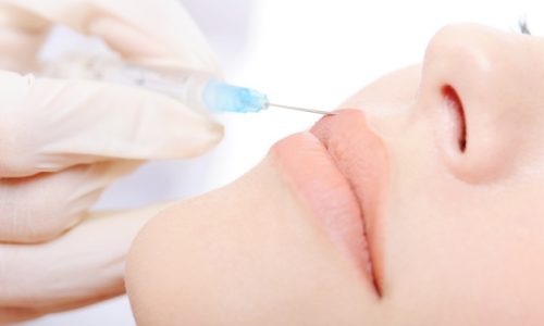 beautician-applying-botox-shot-lips-young-woman_186202-2371